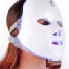 Woman relaxing with the LED face mask on, blue light mode